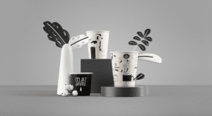 Schvarz Rebranding vom Studio B-O-B- schwarzweiß und mit feinen Linien illustriert sieht man die Pappbecher mit Kaffeehaus-Motiven