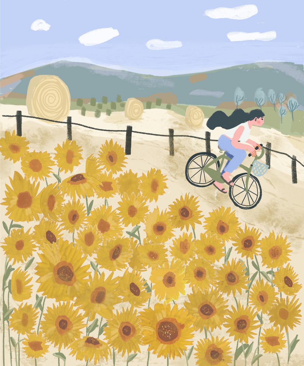 Digitale Illustration von Noemi Fabra. Sie zeigt eine Frau, die bei blauem Himmel auf einem Fahrrad durch ein gelbes Blumenfeld fährt.