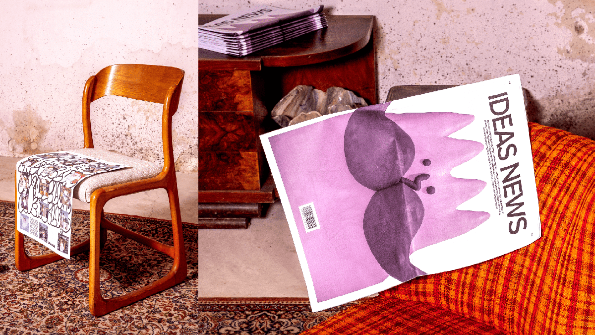 Die Agenturzeitung liegt auf einem 60er-Jahre Stuhl und auf einem dunklen Holztisch