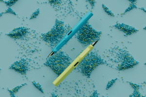 Zwei Lamy-Füller Modell safari schwebend auf blauem Hintergrund mit chladnischen Granulatmustern, in den Farben Limette, sattes Himmelblau