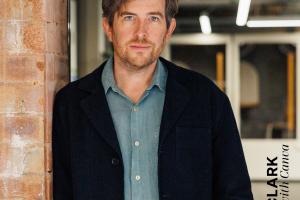 Portrait von Duncan Clark, Head of Canva EMEA. Er lehnt an einer Wand