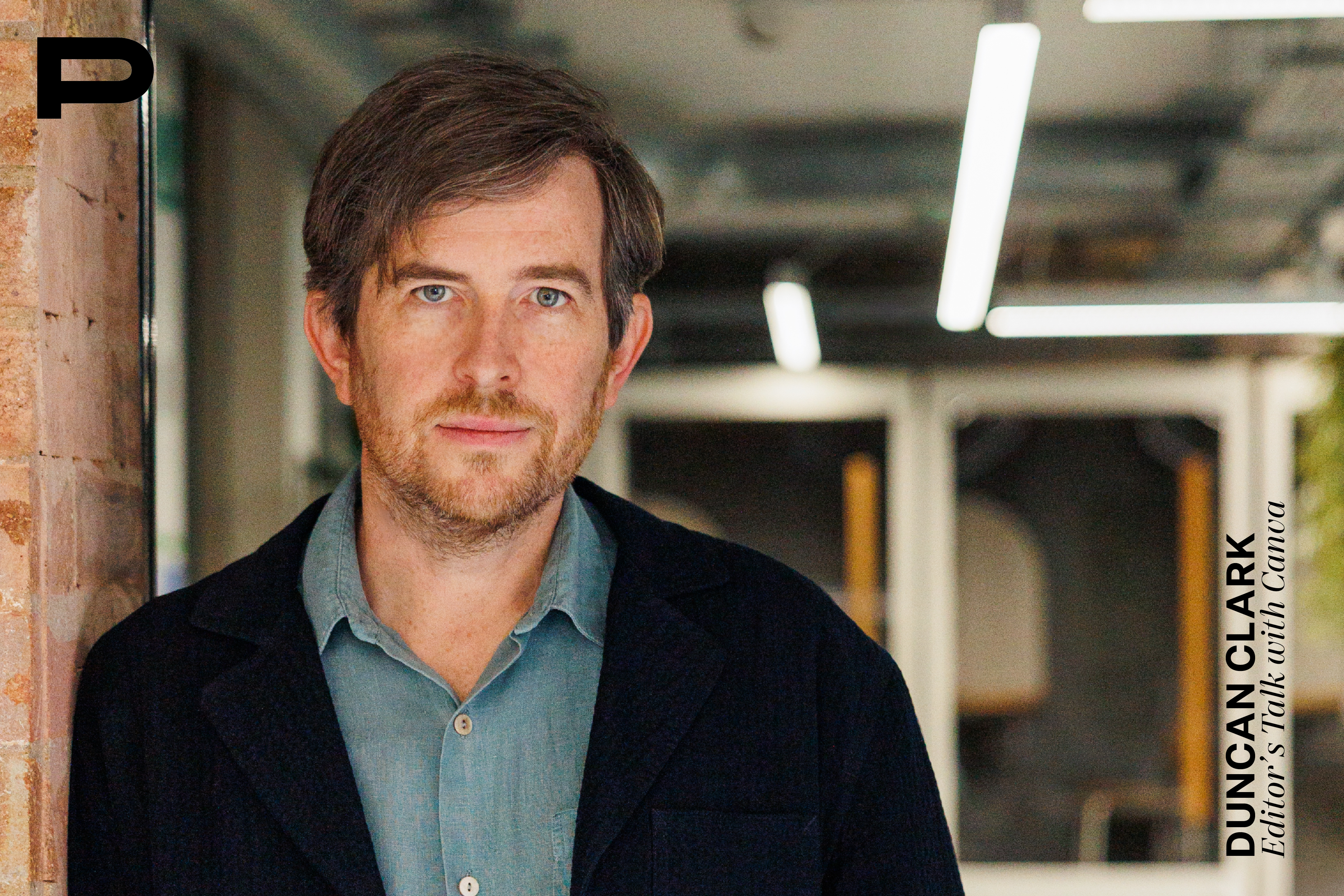 Portrait von Duncan Clark, Head of Canva EMEA. Er lehnt an einer Wand
